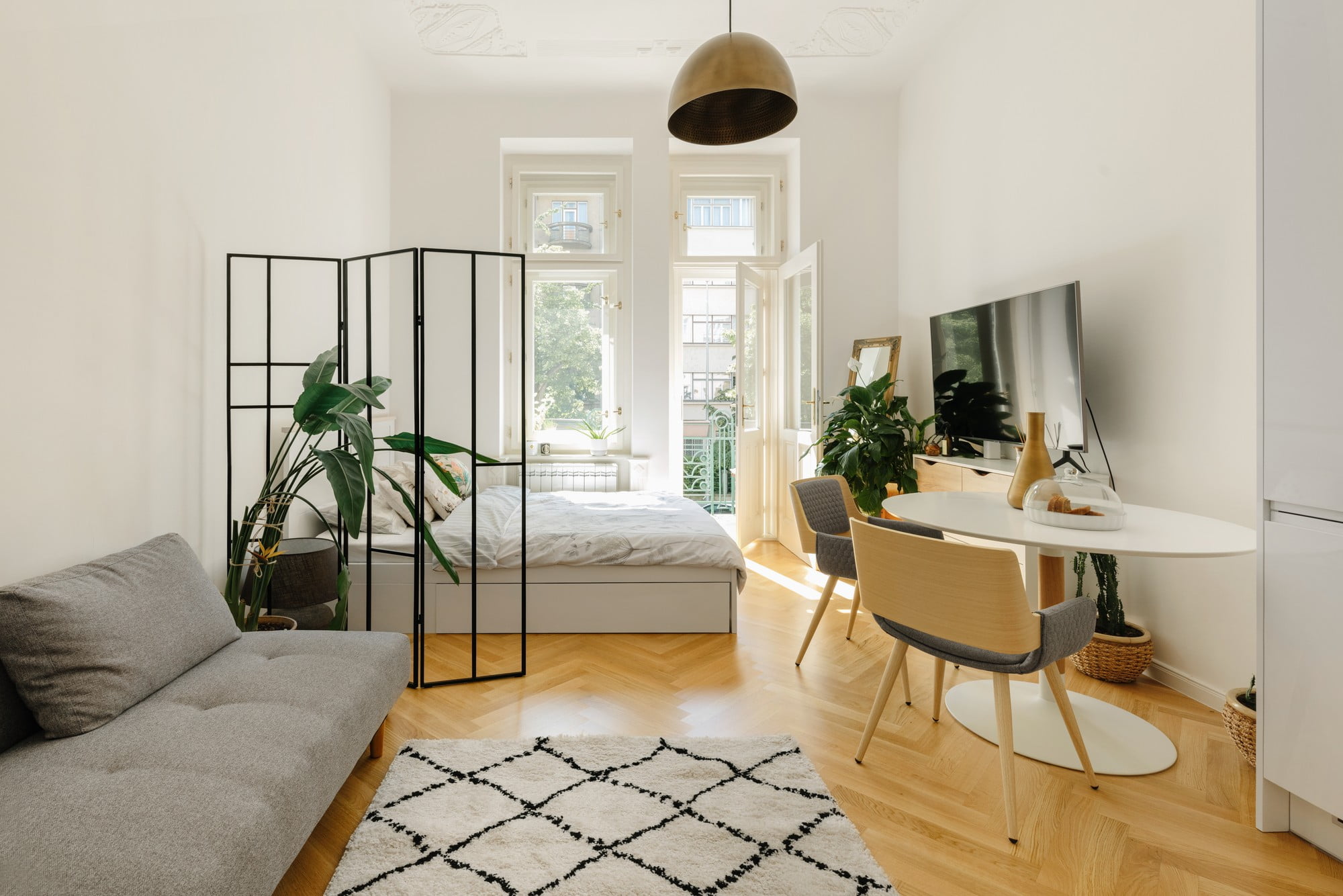 Ryškios ir neutralios spalvos ant sienų ir baldų vizualiai padidina vieno kambario butą.